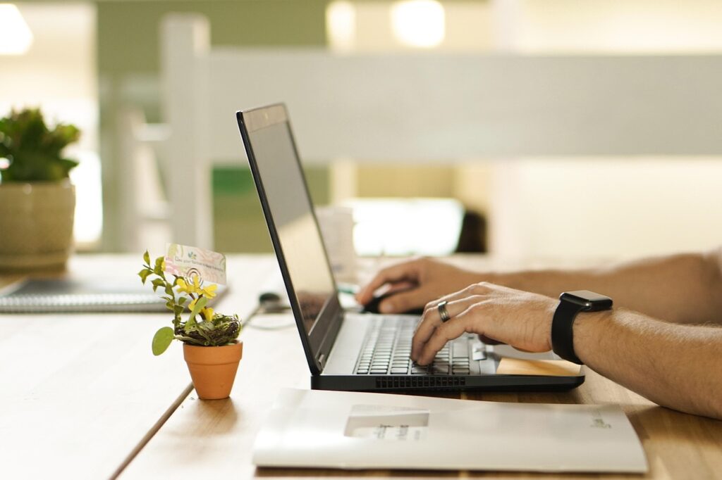 Student working from home as a customer support representative on a laptop.