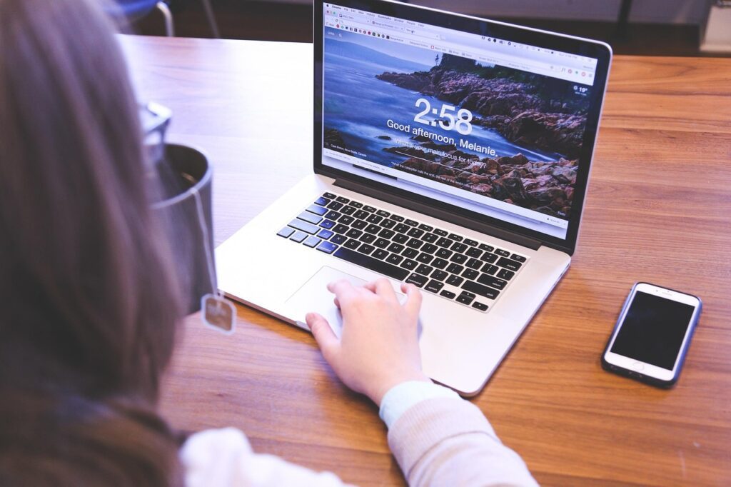 Student doing freelance graphic design work on a laptop as a beginner.
