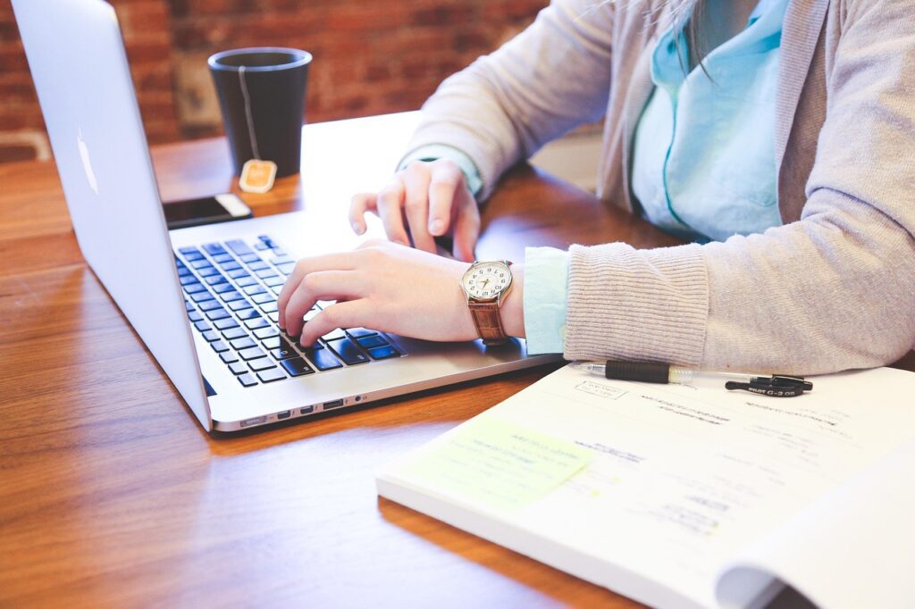 Student doing online content writing for freelancing jobs in 2025 on a laptop