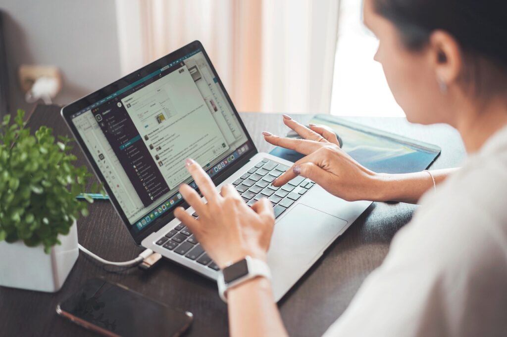 Student working on a laptop doing data entry freelancing from home.